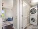 Convenient laundry area with stacked washer and dryer, seamlessly connected to the playroom at 7805 Crooked Creek Church Rd, Monroe, NC 28110