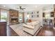 Bright living room featuring a stone fireplace, neutral-toned furniture, and ample natural light at 7805 Crooked Creek Church Rd, Monroe, NC 28110