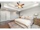 Beautiful main bedroom with hardwood floors, tray ceiling, ceiling fan and neutral color palette at 7805 Crooked Creek Church Rd, Monroe, NC 28110
