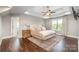 Spacious main bedroom with tray ceiling, ceiling fan, large rug, and ensuite bathroom at 7805 Crooked Creek Church Rd, Monroe, NC 28110
