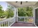 Covered balcony with white railings overlooks lush greenery and water views at 795 Peninsula Dr, Davidson, NC 28036
