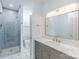 Modern bathroom featuring gray vanity, gold fixtures, and a tiled walk-in shower at 795 Peninsula Dr, Davidson, NC 28036