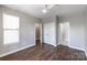 Bright bedroom featuring a modern ceiling fan, hardwood floors, and neutral paint at 795 Peninsula Dr, Davidson, NC 28036