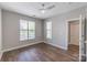 Spacious bedroom featuring hardwood floors, a ceiling fan, and large windows at 795 Peninsula Dr, Davidson, NC 28036