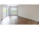 Spacious bedroom with a sliding door to a private balcony, large window and beautiful hardwood floors at 795 Peninsula Dr, Davidson, NC 28036