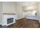Open living space with a fireplace and view into the updated kitchen with island seating at 795 Peninsula Dr, Davidson, NC 28036
