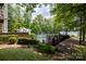 Community pool area surrounded by lush landscaping and mature trees at 795 Peninsula Dr, Davidson, NC 28036