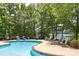 Community swimming pool with lounge chairs surrounded by lush landscaping at 795 Peninsula Dr, Davidson, NC 28036