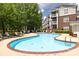 Community pool with lounge chairs and a brick surround provides outdoor recreation at 795 Peninsula Dr, Davidson, NC 28036