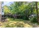 Large backyard features a two-level deck and shed surrounded by vibrant green trees at 80 Lecline Ne Cir, Concord, NC 28025