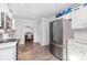 Well-lit kitchen with stainless steel appliances, white cabinets, and durable wood-look flooring at 80 Lecline Ne Cir, Concord, NC 28025