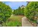 Backyard features lush green bushes lining the pathway to the home at 8232 Sunset Hill Rd # Th88, Waxhaw, NC 28173