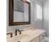 Bathroom vanity with a large framed mirror and bronze fixtures at 8232 Sunset Hill Rd # Th88, Waxhaw, NC 28173