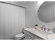 Clean bathroom featuring a shower, modern sink, and a sleek, round mirror at 8232 Sunset Hill Rd # Th88, Waxhaw, NC 28173