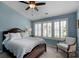 Comfortable bedroom with a ceiling fan and windows featuring shutter-style blinds at 8232 Sunset Hill Rd # Th88, Waxhaw, NC 28173