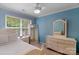 Bright bedroom with light blue walls, a large window, and light-colored furniture at 8232 Sunset Hill Rd # Th88, Waxhaw, NC 28173