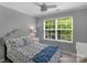 Cozy bedroom with a large window providing ample natural light and a ceiling fan at 8232 Sunset Hill Rd # Th88, Waxhaw, NC 28173
