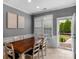 Bright dining room with a large wooden table, seating for six, and access to the outdoor space at 8232 Sunset Hill Rd # Th88, Waxhaw, NC 28173
