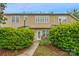 Townhome with a private back patio area, surrounded by green bushes at 8232 Sunset Hill Rd # Th88, Waxhaw, NC 28173