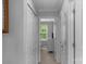 Hallway with white doors, leading to a room with a view of lush greenery at 8232 Sunset Hill Rd # Th88, Waxhaw, NC 28173