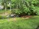 Secluded backyard featuring a small waterfall, lush greenery, and mature trees for ultimate relaxation and privacy at 824 6Th Nw St # 5, Hickory, NC 28601