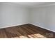 Empty room featuring wood-look flooring, neutral walls, and crown molding at 824 6Th Nw St # 5, Hickory, NC 28601