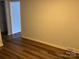 Neutral bedroom showing wood-look flooring and view into another room at 824 6Th Nw St # 5, Hickory, NC 28601