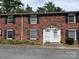 Close-up of brick townhome exterior, showcasing dual entrances and black shutters at 824 6Th Nw St # 5, Hickory, NC 28601