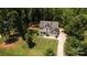 Aerial view showing manicured lawns, large driveway, and the surrounding trees at 8402 Aspen Ct, Charlotte, NC 28227