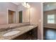 Bathroom with granite countertops, double sinks, and wood cabinets at 8402 Aspen Ct, Charlotte, NC 28227