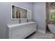 Modern bathroom with a large vanity, dual sinks, and contemporary lighting at 8402 Aspen Ct, Charlotte, NC 28227