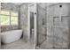 Luxurious bathroom with a freestanding tub, glass shower, and elegant marble accents at 8402 Aspen Ct, Charlotte, NC 28227