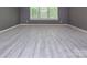 Spacious bedroom with large windows and light hardwood floors at 8402 Aspen Ct, Charlotte, NC 28227