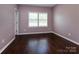 Bedroom featuring plantation shutters and rich wood flooring at 8402 Aspen Ct, Charlotte, NC 28227