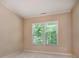 Neutral bedroom featuring a bright window with views of the surrounding greenery at 8402 Aspen Ct, Charlotte, NC 28227