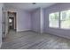 Bright bedroom with a large window, neutral walls, and wood-look floors at 8402 Aspen Ct, Charlotte, NC 28227