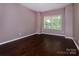 Cozy bedroom with a large window and hardwood floors at 8402 Aspen Ct, Charlotte, NC 28227