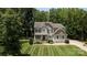Exterior shot showing manicured front lawn and covered entryway at 8402 Aspen Ct, Charlotte, NC 28227
