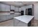 Well-equipped kitchen with sleek gray cabinets, stainless steel appliances, and a marble-topped island at 8402 Aspen Ct, Charlotte, NC 28227