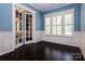 Home office with French doors, hardwood floors, and plantation shutters at 8402 Aspen Ct, Charlotte, NC 28227
