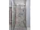 Luxurious tiled shower with built-in shelves and a glass door enclosure at 8402 Aspen Ct, Charlotte, NC 28227