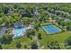 Aerial view of community pool, clubhouse and tennis courts surrounded by mature trees and beautiful homes at 9427 Gilpatrick Ln # 5, Huntersville, NC 28078