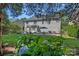 Landscaped backyard with a patio, fire pit, outdoor dining area, grill, and lush greenery at 9427 Gilpatrick Ln # 5, Huntersville, NC 28078