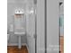 Bathroom featuring white fixtures and a pedestal sink, complemented by hardwood flooring at 9427 Gilpatrick Ln # 5, Huntersville, NC 28078