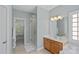 Bathroom with double sinks, wood cabinets, tile floor and walk-in shower with glass door at 9427 Gilpatrick Ln # 5, Huntersville, NC 28078