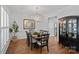 Elegant dining room with a modern chandelier, hardwood floors, and sophisticated decor at 9427 Gilpatrick Ln # 5, Huntersville, NC 28078