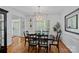 Stylish dining room featuring hardwood floors, plantation shutters, and a modern lighting fixture at 9427 Gilpatrick Ln # 5, Huntersville, NC 28078