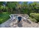 Outdoor patio with stone fire pit, Adirondack chairs, and lush landscaping provides a cozy gathering space at 9427 Gilpatrick Ln # 5, Huntersville, NC 28078
