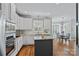 Open kitchen with white cabinets, granite countertops, stainless appliances, and breakfast area with natural light at 9427 Gilpatrick Ln # 5, Huntersville, NC 28078