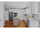 Bright kitchen features white cabinets, granite counters, stainless steel appliances, and wood flooring at 9427 Gilpatrick Ln # 5, Huntersville, NC 28078